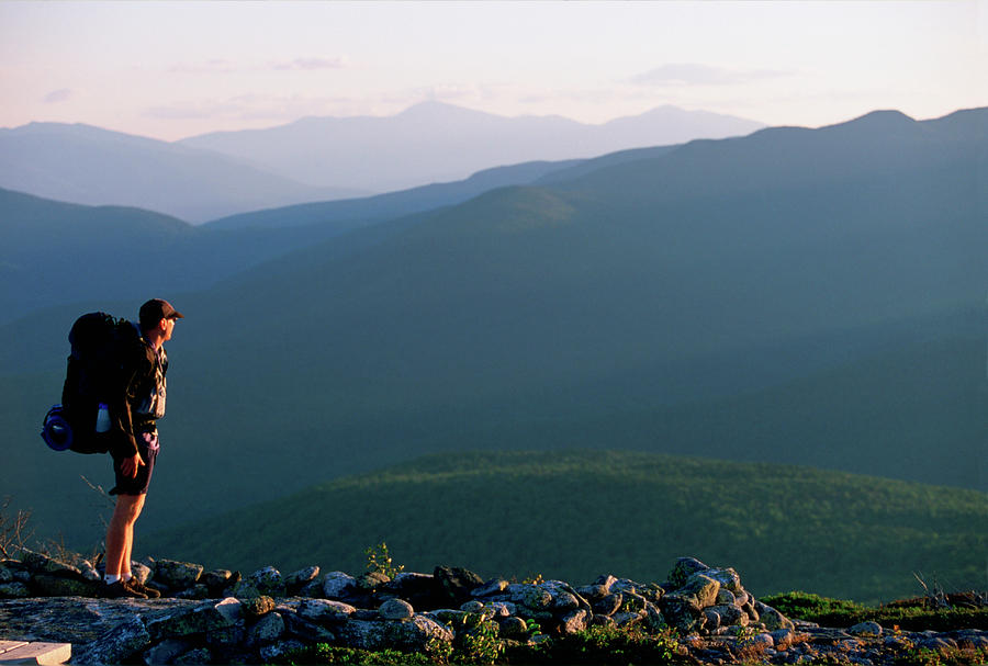 A Hiker Looks Out At The Mountains Photograph by Nick Lambert - Pixels